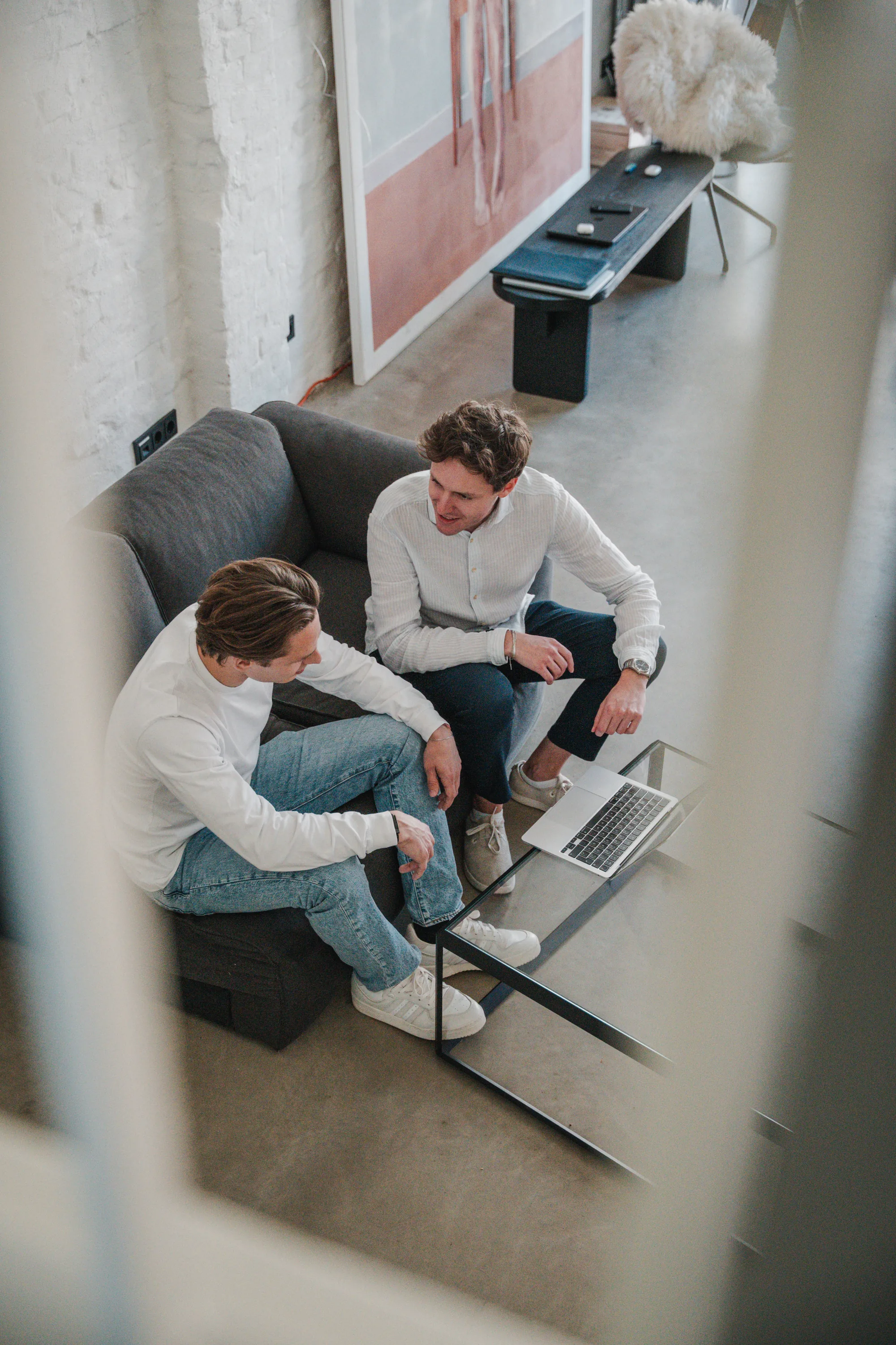 Two Uplane team members collaborating around a laptop